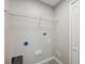 A utilitarian laundry room with connections, tile floors and ventilation at 12534 Chenwood Ave, Hudson, FL 34669