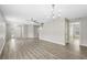 Bright living room with hardwood floors and open concept leading to the stairway and front door at 12534 Chenwood Ave, Hudson, FL 34669