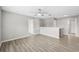 Spacious loft area boasts wood-look floors, ceiling fan, and multiple doorways at 12534 Chenwood Ave, Hudson, FL 34669