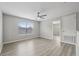 Second-floor loft area with wood-look flooring and views from the large window at 12534 Chenwood Ave, Hudson, FL 34669