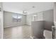 Upstairs loft space with wood-look flooring and large window letting in natural light at 12534 Chenwood Ave, Hudson, FL 34669