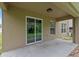 Covered patio with sliding glass door and neutral paint tones provides a relaxing outdoor space at 12534 Chenwood Ave, Hudson, FL 34669
