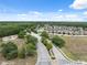 Aerial view showcases community entrance road with pond and residential street at 12534 Chenwood Ave, Hudson, FL 34669