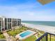 Scenic aerial view of condo building with ocean views, pool and beach access at 1400 Gulf Blvd # 701, Clearwater Beach, FL 33767