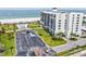 Elevated view of the condo building, pool, parking, and beachfront access at 1400 Gulf Blvd # 701, Clearwater Beach, FL 33767