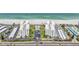 An aerial view of the beachfront condo buildings, swimming pool, parking lot, and meticulously kept grounds at 1400 Gulf Blvd # 701, Clearwater Beach, FL 33767