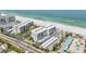 Aerial view of condo buildings with beach access, parking, and landscaping at 1400 Gulf Blvd # 701, Clearwater Beach, FL 33767