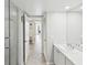 Bathroom featuring a shower with glass door, sink, closet, and entryway with an open door at 1400 Gulf Blvd # 701, Clearwater Beach, FL 33767