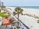 Expansive beach view featuring tiki huts, a sandy beach, and ocean waters at 1400 Gulf Blvd # 701, Clearwater Beach, FL 33767