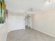 Bedroom featuring a ceiling fan, closet, and view into hallway. Decorative wall hangings give it a nice touch at 1400 Gulf Blvd # 701, Clearwater Beach, FL 33767