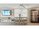 Dining room featuring glass table with seating for six, lit display cabinet, and beach-themed decor at 1400 Gulf Blvd # 701, Clearwater Beach, FL 33767