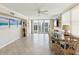 Open dining room with tile floors, ceiling fan, access to balcony, and bright, airy atmosphere at 1400 Gulf Blvd # 701, Clearwater Beach, FL 33767