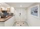 A tiled hallway reveals the entrance to the modern kitchen at 1400 Gulf Blvd # 701, Clearwater Beach, FL 33767