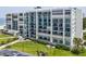 Elegant condo building with rows of balconies and lush tropical landscaping at 1400 Gulf Blvd # 701, Clearwater Beach, FL 33767