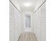 Hallway with ample closet storage leading to bathroom at 1400 Gulf Blvd # 701, Clearwater Beach, FL 33767