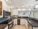 A bright kitchen features stainless steel appliances, granite countertops, and ample cabinet space at 1400 Gulf Blvd # 701, Clearwater Beach, FL 33767