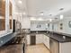 Bright kitchen with white cabinets, granite countertops, stainless steel appliances, and breakfast bar at 1400 Gulf Blvd # 701, Clearwater Beach, FL 33767