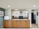 Condo kitchenette featuring granite countertops, wooden cabinets, range and microwave at 1400 Gulf Blvd # 701, Clearwater Beach, FL 33767