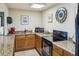 Condo kitchenette featuring granite countertops, wooden cabinets, range, sink and microwave at 1400 Gulf Blvd # 701, Clearwater Beach, FL 33767