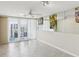 Bright living room featuring mirrored wall, ceiling fan, and access to a balcony with beautiful views at 1400 Gulf Blvd # 701, Clearwater Beach, FL 33767
