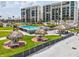 Beautiful beachside pool with tiki huts, lush landscaping, and ocean views at 1400 Gulf Blvd # 701, Clearwater Beach, FL 33767