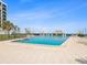 Community pool with ocean view and lounge chairs at 1400 Gulf Blvd # 701, Clearwater Beach, FL 33767
