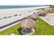 Aerial view of tiki huts on a manicured lawn with beach access at 1400 Gulf Blvd # 701, Clearwater Beach, FL 33767