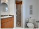 Bathroom features a granite vanity, tiled shower, and neutral walls at 401 Sunset Dr, Venice, FL 34285