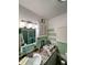 Vintage green and white bathroom with a single sink, vanity, and a shower with green tile at 401 Sunset Dr, Venice, FL 34285