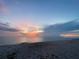 Picturesque beach view with a colorful sunset sky reflecting on the tranquil ocean waters at 401 Sunset Dr, Venice, FL 34285