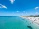 Scenic beach view with clear turquoise water and people enjoying a sunny day at 401 Sunset Dr, Venice, FL 34285