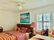 Charming bedroom with bright decor, colorful bedding, and natural light at 401 Sunset Dr, Venice, FL 34285