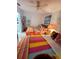 Bright bedroom with two beds and a colorful tropical design at 401 Sunset Dr, Venice, FL 34285