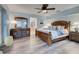 Spacious bedroom featuring wood-look floors, king bed, and neutral walls at 401 Sunset Dr, Venice, FL 34285