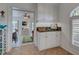 Butler's pantry with shaker cabinets, granite countertops, and tile floors at 401 Sunset Dr, Venice, FL 34285