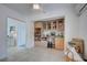 Butler's pantry featuring display shelving, baskets, and light wood cabinets at 401 Sunset Dr, Venice, FL 34285