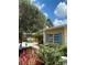 Charming home featuring bright shutters, a lovely front yard, and a tranquil fountain at 401 Sunset Dr, Venice, FL 34285