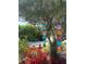 Beautifully landscaped garden featuring colorful buoys, lush plants, and a peaceful bench at 401 Sunset Dr, Venice, FL 34285