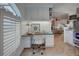 Cozy office space with built in desk, white cabinets, and natural light from the shuttered window at 401 Sunset Dr, Venice, FL 34285