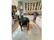 Compact kitchen featuring white cabinetry, stainless steel appliances, and a small dining table at 401 Sunset Dr, Venice, FL 34285