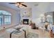 Elegant living room featuring a decorative fireplace, glass coffee table, and stylish decor at 401 Sunset Dr, Venice, FL 34285