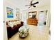 Comfortable living room features a sofa, ottoman, and view of the pool area at 401 Sunset Dr, Venice, FL 34285