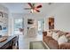 Cozy living room with a comfortable brown sofa and view of the outdoor pool area at 401 Sunset Dr, Venice, FL 34285
