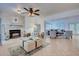 Open living room with fireplace, neutral tile flooring, and classic furniture at 401 Sunset Dr, Venice, FL 34285