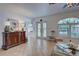 Well-lit living room with neutral tile flooring, console, and an abundance of natural light at 401 Sunset Dr, Venice, FL 34285