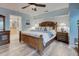 Comfortable primary bedroom with wood look floors and ensuite bathroom at 401 Sunset Dr, Venice, FL 34285
