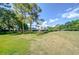 Large backyard featuring mature trees and plenty of space for recreation and relaxation at 16601 W Course Dr, Tampa, FL 33624