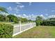 A charming backyard with a white picket fence overlooking a golf course at 16601 W Course Dr, Tampa, FL 33624
