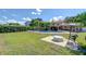 A large backyard with a pool, patio, and lush landscaping, ideal for outdoor living and entertaining at 16601 W Course Dr, Tampa, FL 33624