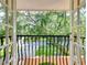Balcony view overlooking a verdant landscape of trees and greenery at 16601 W Course Dr, Tampa, FL 33624